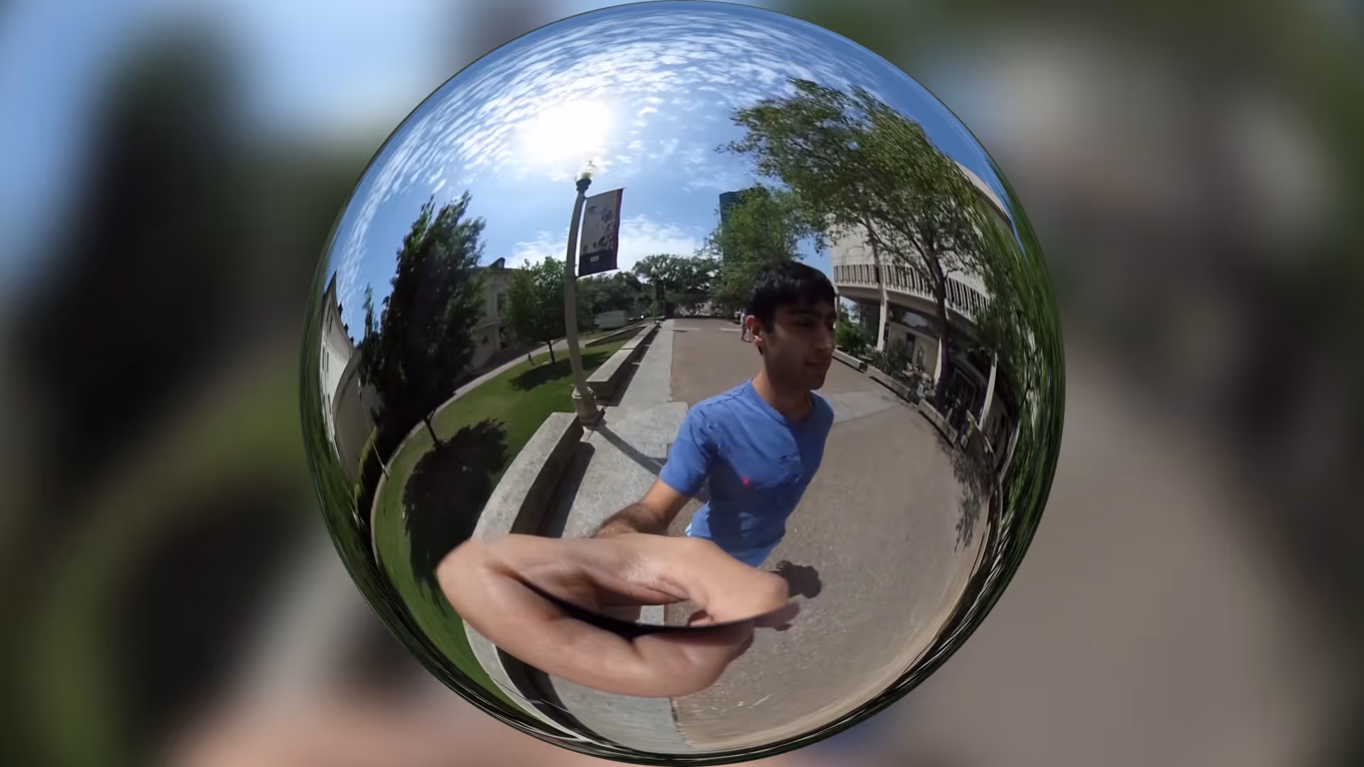 A 360 degree panoramic image of a person walking on a college campus
