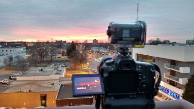 A picture of a camera taking a sunset timelapse