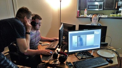 Guys working hard on computers to edit the film